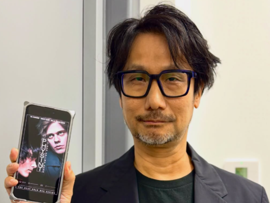 Hideo Kojima Showint a Poster of Physint Image Source Hideo Kojima Instagram